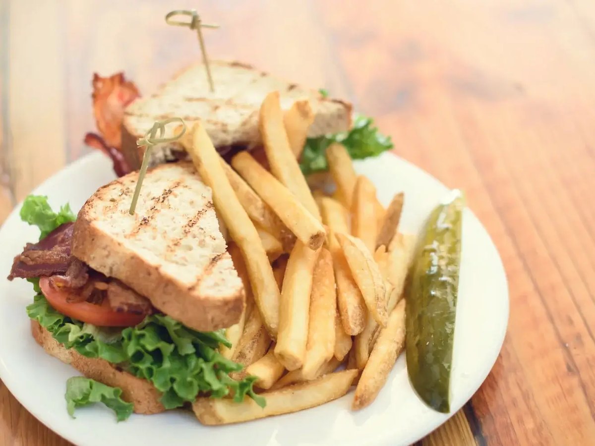 Cozy Method Park City breakfast and brunch guide: a club sandwich with fries and a pickle at The Eating Establishment in Park City