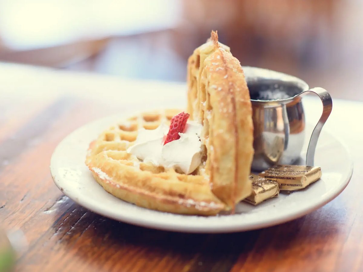 Cozy Method Park City breakfast and brunch guide: a waffle with whipped cream and berries at The Eating Establishment in Park City