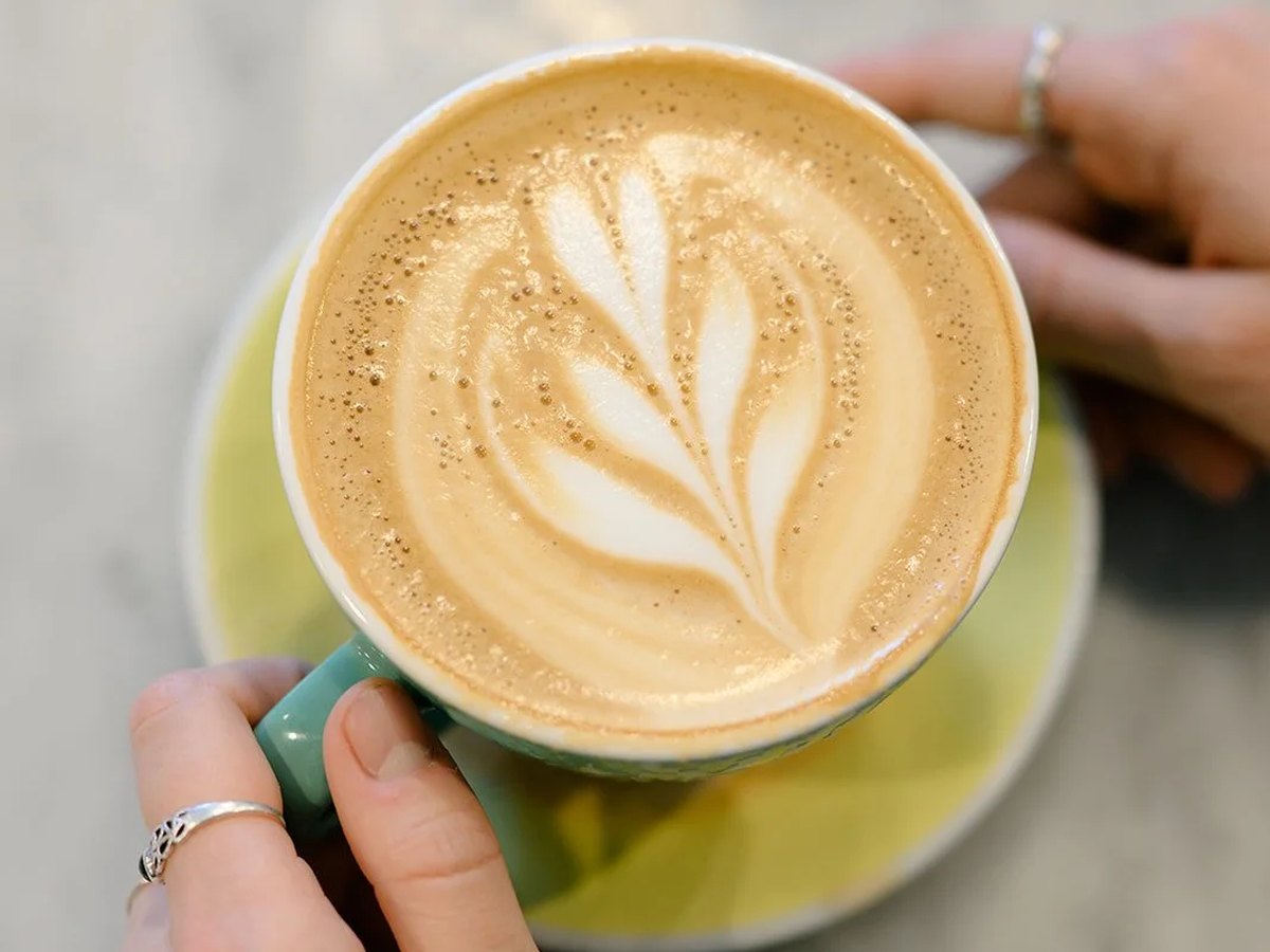 Cozy Method Park City breakfast and brunch guide: a flat white with latte art served at Harvest on Park Avenue, Park City