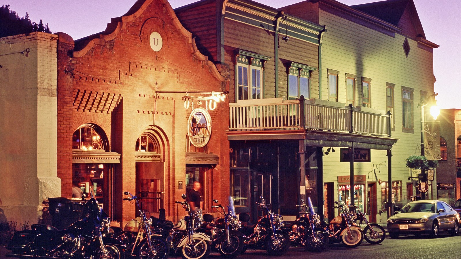 Cozy Method Park City burger guide: the No Name Saloon facade glowing on historic Main Street in Park City at dusk