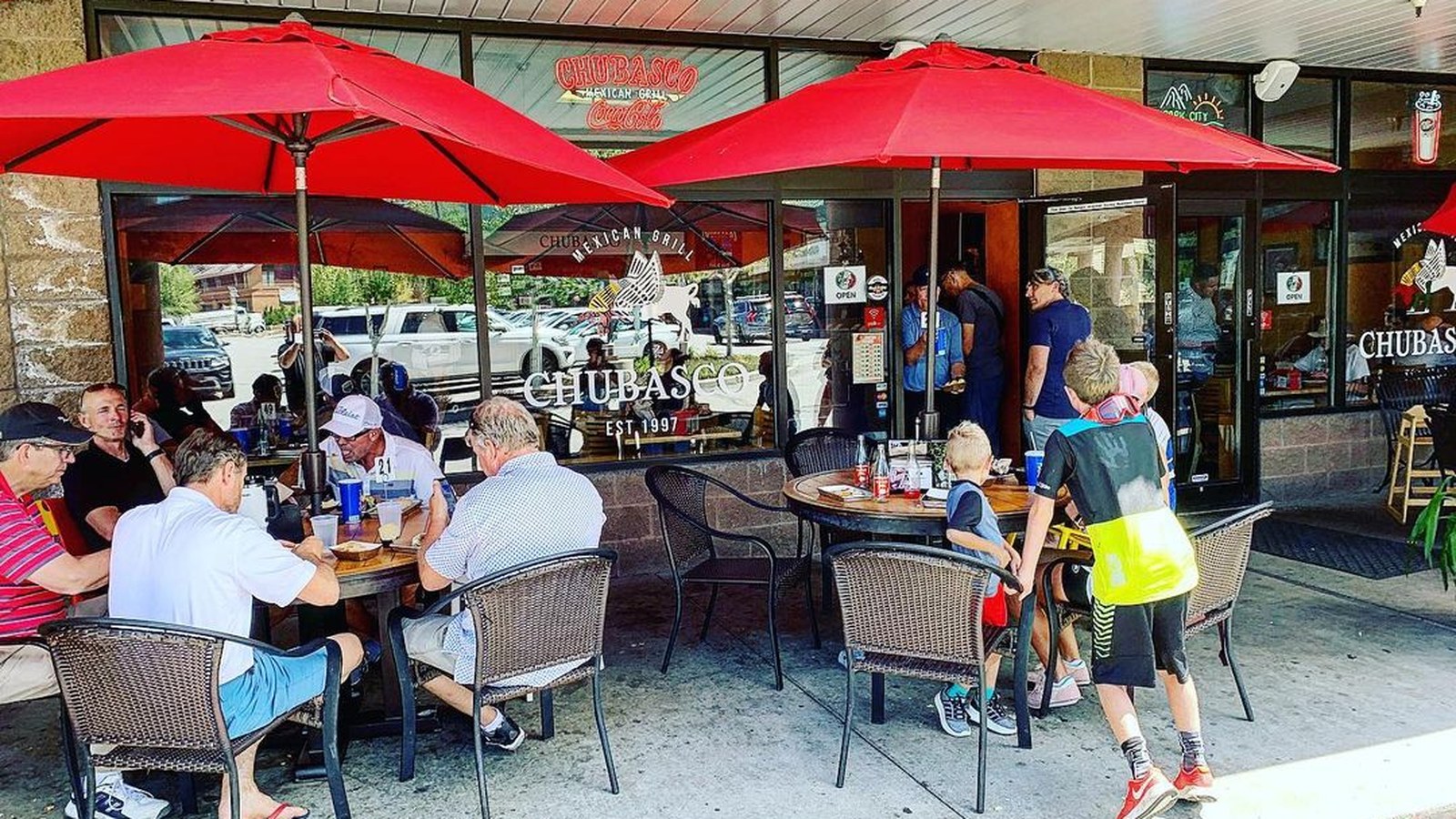 Cozy Method Park City Mexican restaurant guide: the patio under red umbrellas at El Chubasco on Bonanza Drive in Park City