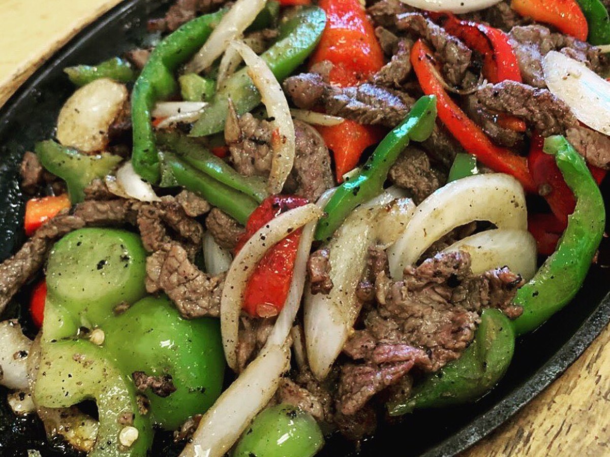 Cozy Method Park City Mexican restaurant guide: sizzling steak fajitas with peppers and onions at El Chubasco in Park City