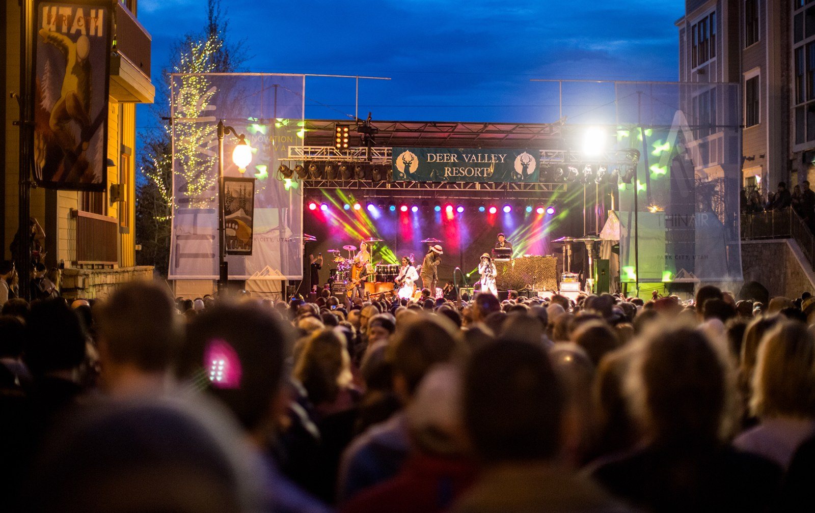 Cozy Method Park City experiences guide: a night stage and crowd at an outdoor summer concert in Park City, Utah