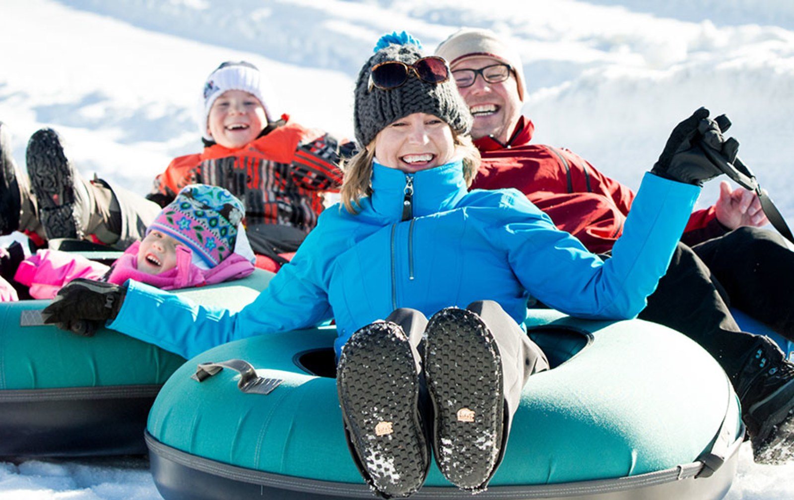 Cozy Method Park City experiences guide: families snow tubing on a winter afternoon in Park City, Utah