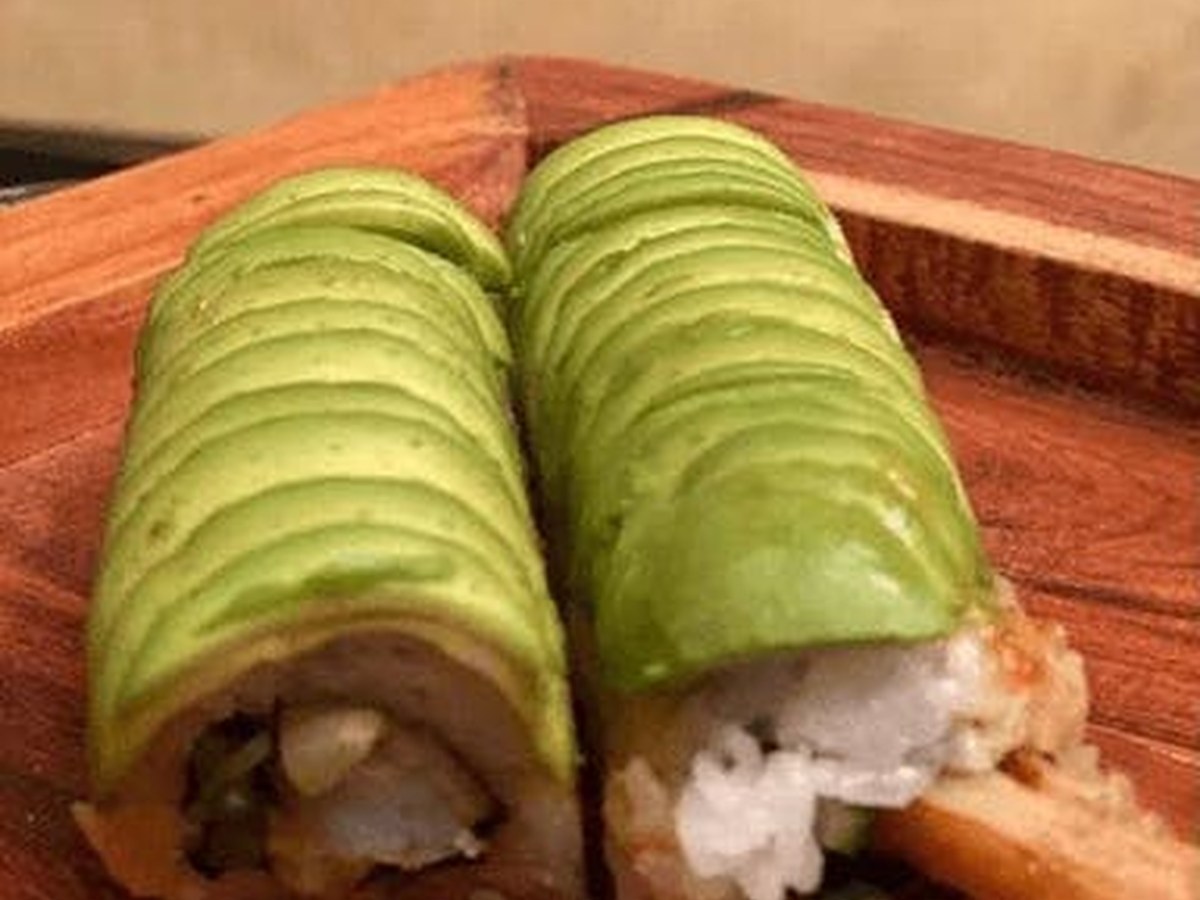 Cozy Method Park City sushi guide: avocado-wrapped roll served on a wood board at Shoyu Sushi House