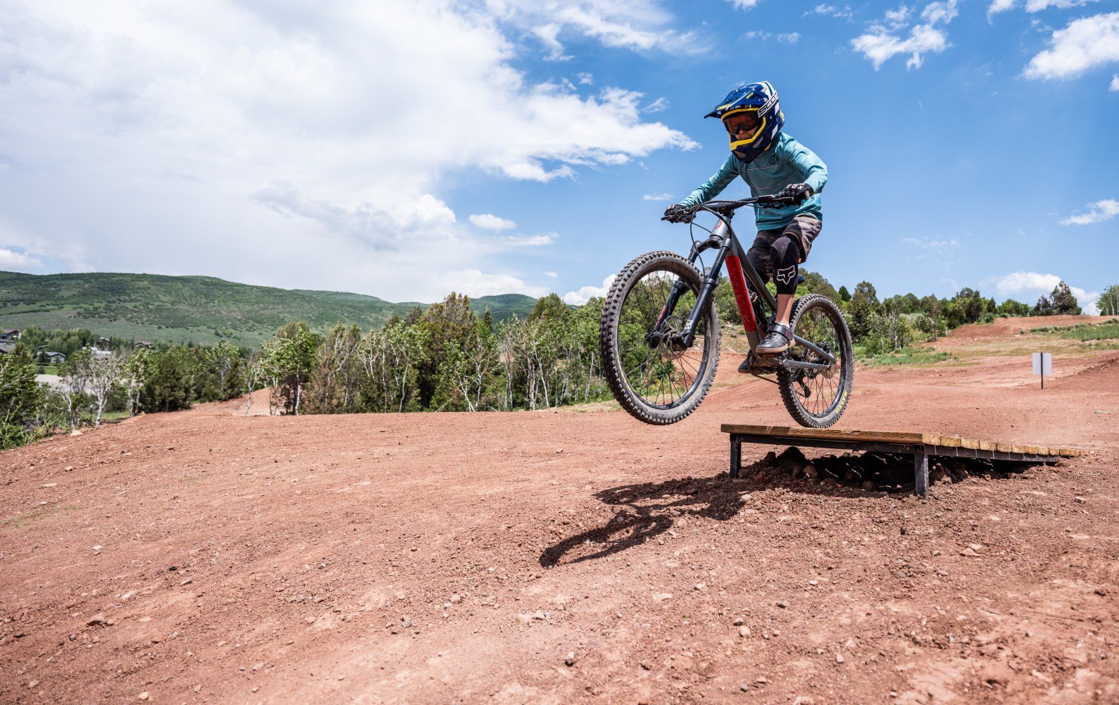 Cozy Method Park City experiences guide: children riding progression features in the bike park at Woodward Park City